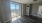 a room with a wood floor and a large window
