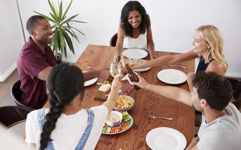 a group of people sitting around a table eating food