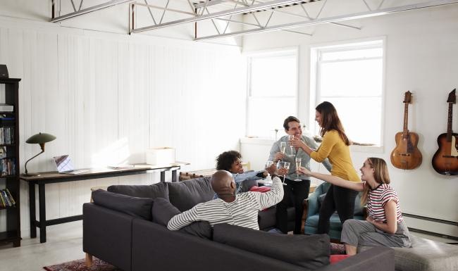 a group of people sitting on a couch in a room with guitars