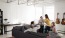 a group of people sitting on a couch in a room with guitars